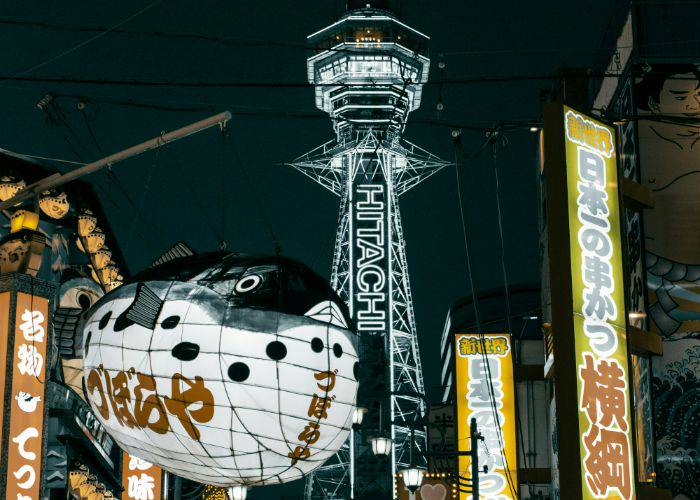 The iconic Tsutentaku Tower and inflatable pufferfish sign in Osaka.